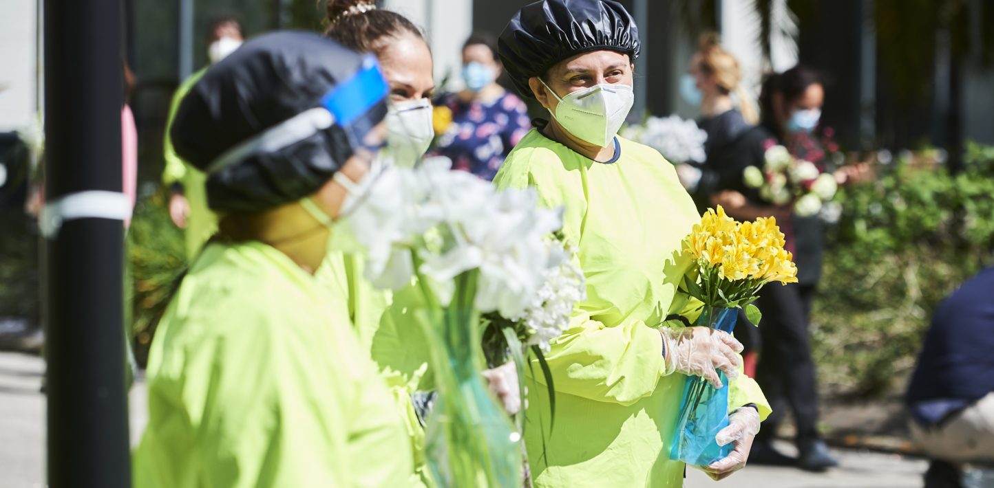 Health workers wearing protective gear applaud during a flash mob at the Elderly Homes San Candido on April 17, 2020 in Santander, Spain