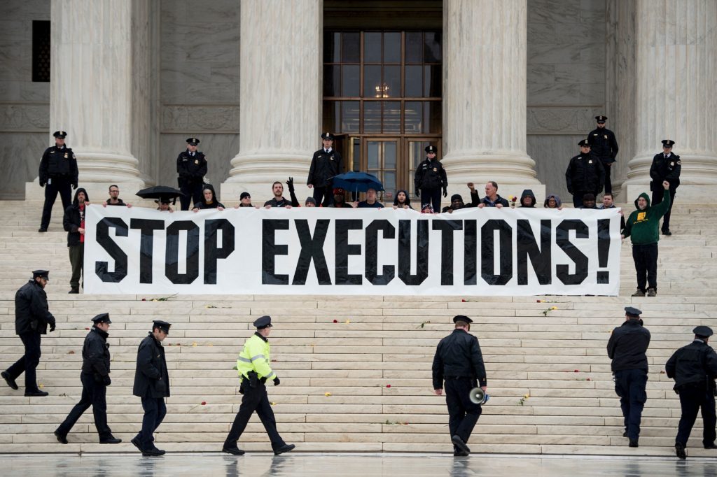 Police officers gather to remove activists during an anti death penalty protest in front of the US Supreme Court